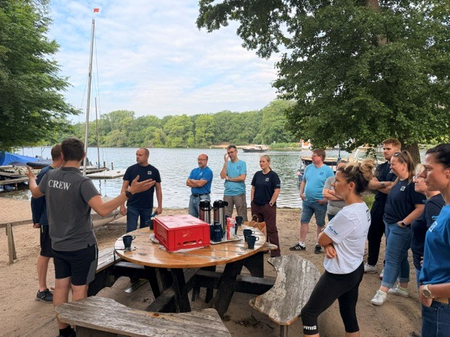 Social Day 2026: Mitarbeiter der Deutschen Bank beim Aufräumen des Wassersportareals